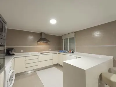 a kitchen with white cabinets and a white counter top at La Llar del Magraner in Barraca de Aguas Vivas