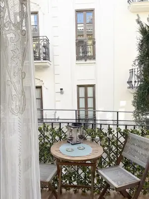 a table on a balcony with two chairs at Nuevo, centrico y luminoso Apartamento casaslacambra in Valencia