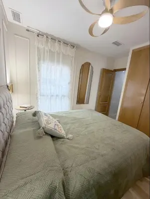 a bedroom with a large bed with a ceiling fan at Nuevo, centrico y luminoso Apartamento casaslacambra in Valencia