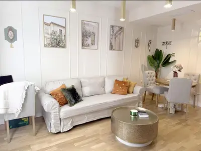 a living room with a white couch and a table at Nuevo, centrico y luminoso Apartamento casaslacambra in Valencia