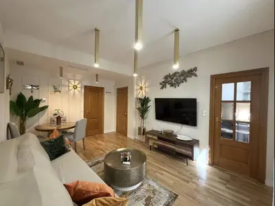 a living room with a couch and a tv at Nuevo, centrico y luminoso Apartamento casaslacambra in Valencia