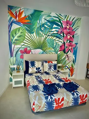 a bedroom with a bed with a flower mural on the wall at Glamour Suite1 next to Plaza de España in Valencia