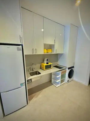 a kitchen with white cabinets and a sink and a refrigerator at Glamour Suite1 next to Plaza de España in Valencia