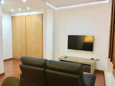 a living room with a couch and a flat screen tv at Historic city center in Valencia