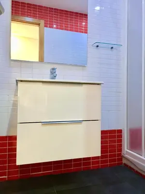 a kitchen with a white sink and red tiles at Historic city center in Valencia