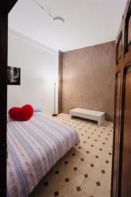 a bedroom with a bed with a red pillow on it at Alquiler Hab Centro Valencia in Valencia