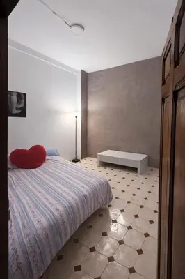 a bedroom with a bed with a red pillow on it at Alquiler Hab Centro Valencia in Valencia