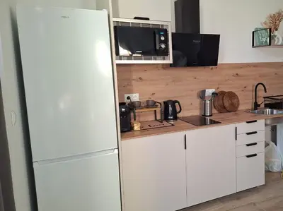 a kitchen with a white refrigerator and a sink at ConchaBeach Valencia in Valencia