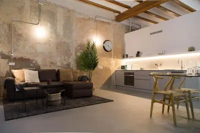 a living room with a couch and a table and a kitchen at Can Turia in Valencia