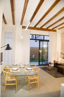 a living room with a glass table and chairs at Can Turia in Valencia