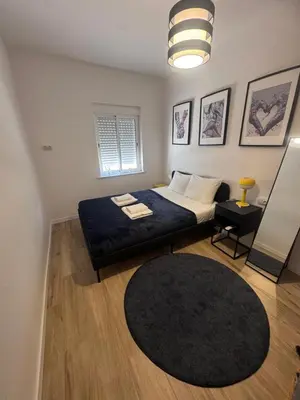 a bedroom with a bed and a black rug at Large New House with Terraces and Air Conditioning in Cullera