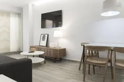 a living room with a couch and a table at Austria 4 in Valencia