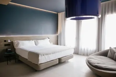 a bedroom with a large bed and a couch at MYR Plaza Mercado & Spa in Valencia