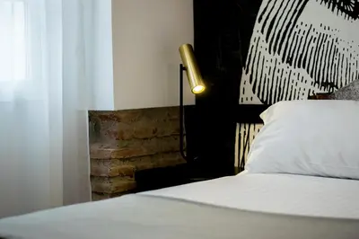a bedroom with a bed with a white pillow and a lamp at MYR Plaza Mercado & Spa in Valencia