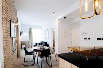 a kitchen and dining room with a table and chairs at MYR Plaza Mercado & Spa in Valencia