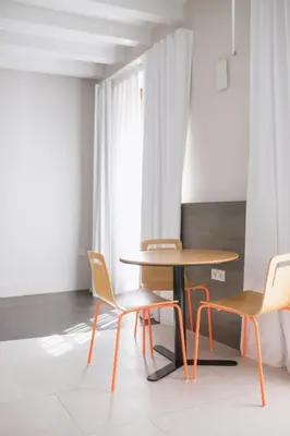 a table and two chairs in a room at MYR Plaza Mercado & Spa in Valencia