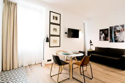 a living room with a table and chairs and a couch at MYR Plaza Mercado & Spa in Valencia