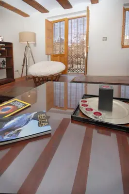 a living room with a table with a laptop on it at Beds & Breaks Ravel I in Valencia