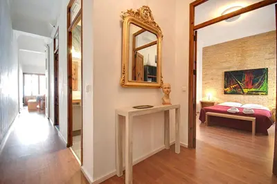 a bedroom with a white bed and a brick wall at Beds & Breaks Strauss in Valencia