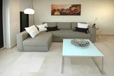 a living room with a tv and a black entertainment center at Beds & Breaks Soler in Valencia