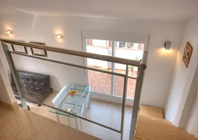 a living room with a couch and a staircase at Beds & Breaks Pergolesi in Valencia