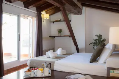 a bedroom with two beds and a large window at SingularStays Botanico29 in Valencia