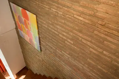 a brick wall with a painting on it at SingularStays Botanico29 in Valencia