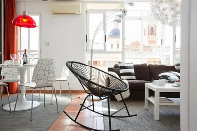 a living room with a couch and a table at SingularStays Botanico29 in Valencia
