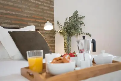 a tray of food and a glass of orange juice at SingularStays Botanico29 in Valencia