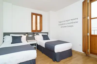 a room with two beds and a desk in it at Valencia Home Carmen in Valencia