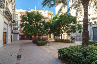 a city street with palm trees and a building at Valencia Home Carmen in Valencia