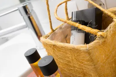 a basket with two bottles of essential oils in it at SingularStays Botanico 29 Rooms in Valencia