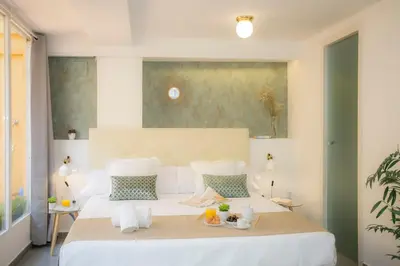 a bedroom with a large white bed with white sheets at SingularStays Botanico 29 Rooms in Valencia
