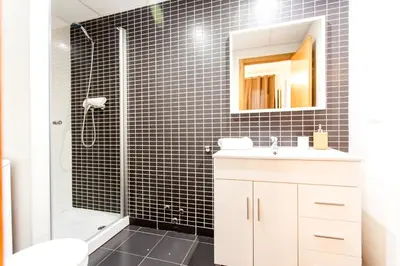 a bathroom with a shower and a sink and a mirror at Total Valencia Old City Luxury in Valencia