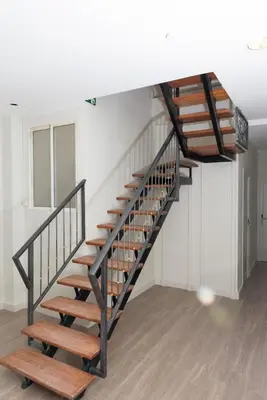 a spiral staircase in a room with wooden floors at NWT Central Station Valencia in Valencia
