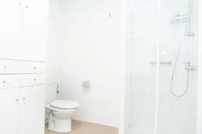 a white bathroom with a toilet and a shower at Valencia Luxury - Boutique Center in Valencia