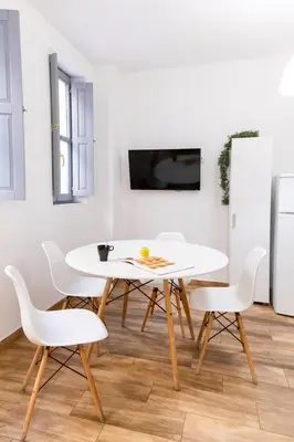 a white dining room with a white table and white chairs at Down Town in Valencia