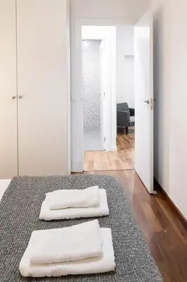 two white towels sitting on a rug in a room at Down Town in Valencia