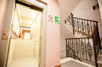 a hallway with a door and stairs in a building at Host & Home in Valencia