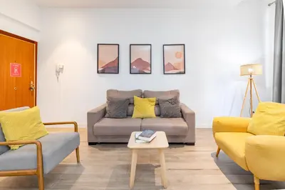 a living room with a couch and two chairs at Travel Habitat Ayuntamiento in Valencia