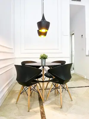 a dining room with a black table and chairs at Baron Suites Reina in Valencia