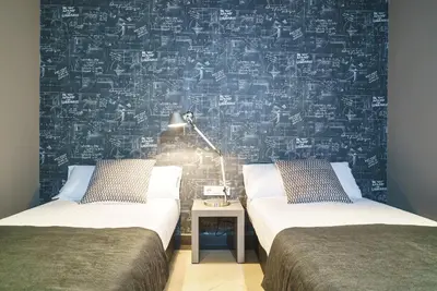 two beds in a room with a wall covered in equations at Valencia Luxury - Boutique Paz in Valencia