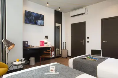 a bedroom with two beds and a desk with a laptop at Casual Vintage Valencia in Valencia