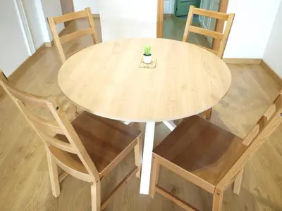 a wooden table with chairs and a potted plant on it at ApartUP Patacona Beach I in Valencia