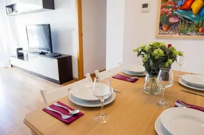 a dining room table with plates and wine glasses at Medinaceli airco, wifi and free parking in Valencia