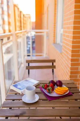 a table with a cup of coffee and fruit and vegetables at Medinaceli airco, wifi and free parking in Valencia