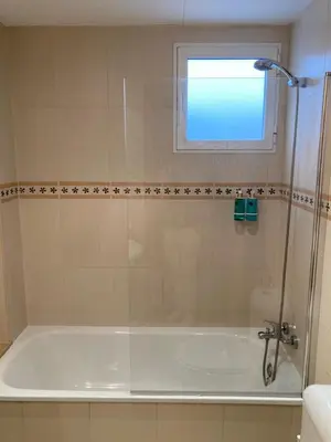 a bathroom with a bath tub with a window at Medinaceli airco, wifi and free parking in Valencia