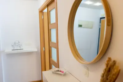 a mirror on a wall next to a table in a room at Medinaceli airco, wifi and free parking in Valencia