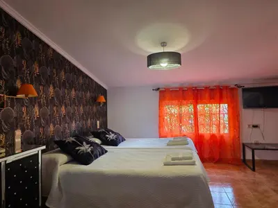 a bedroom with a bed with fish on the wall at Hotel Iris La Eliana in La Eliana