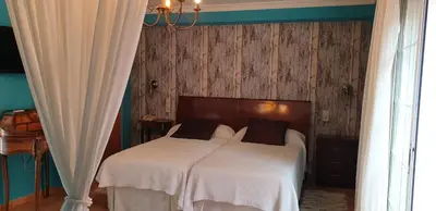 a small bedroom with a bed and a bathroom at Hotel Iris La Eliana in La Eliana